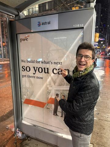 Jonas next to a PwC ad